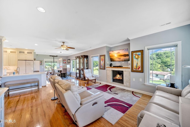 788 Watauga Rd, Watauga, TN 37694 - living room featuring light wood-style flooring, ornamental molding, ceiling fan, a premium fireplace, and recessed lighting