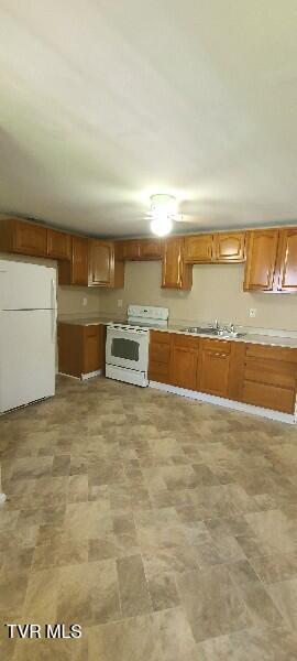 1814 Park St, Kingsport, TN 37664 - kitchen featuring white appliances, light countertops, and brown cabinets