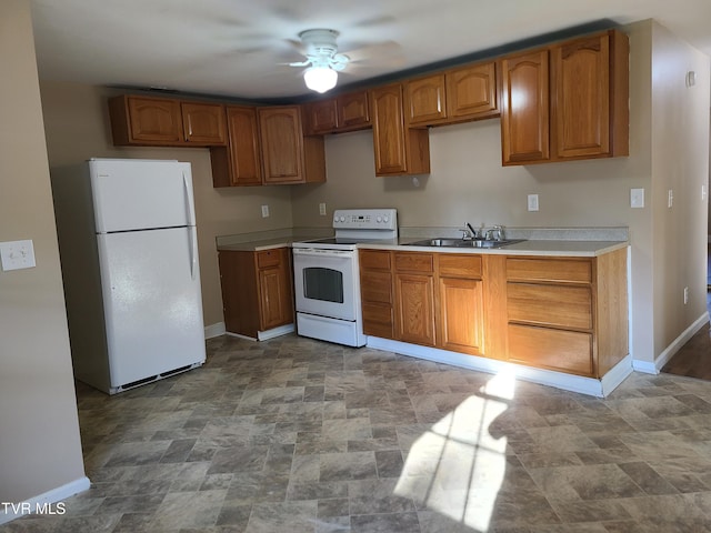 1814 Park St, Kingsport, TN 37664 - kitchen featuring white appliances, stone finish flooring, ceiling fan, brown cabinets, and light countertops