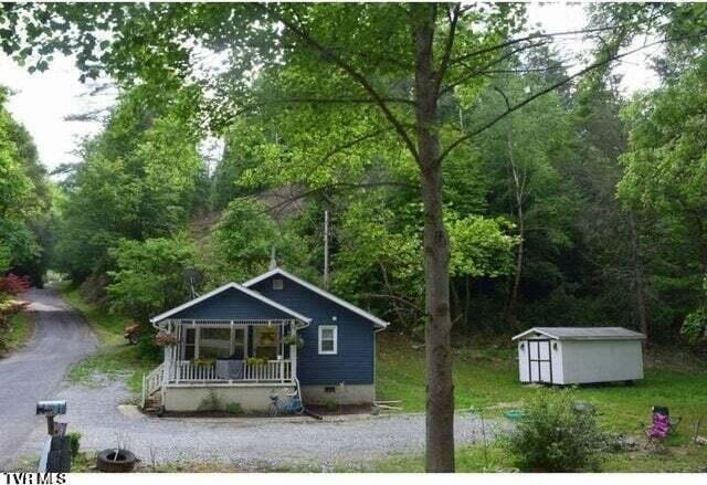 500 Guy Lloyd Rd, Erwin, TN 37650 - bungalow-style home with a porch, a storage shed, a view of trees, and crawl space