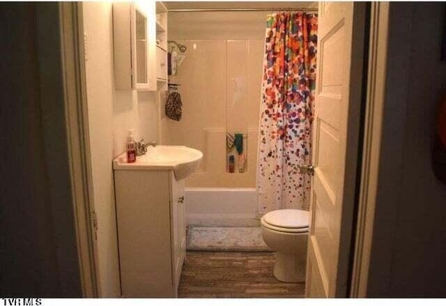 500 Guy Lloyd Rd, Erwin, TN 37650 - bathroom with vanity, shower / bathtub combination with curtain, and wood finished floors