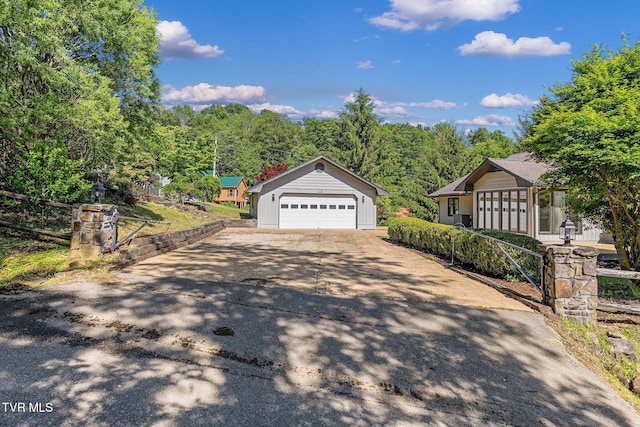 119 Orchard Meadows Ln, Roan Mountain, TN 37687 - view of front of property with a detached garage, an outdoor structure, and asphalt driveway