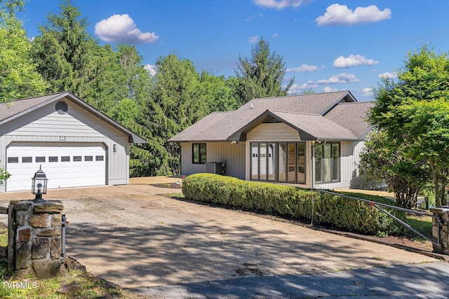 119 Orchard Meadows Ln, Roan Mountain, TN 37687 - view of front facade with driveway, a garage, roof with shingles, and an outdoor structure
