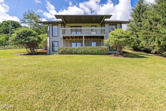 119 Orchard Meadows Ln, Roan Mountain, TN 37687 - rear view of house with a yard, stone siding, board and batten siding, and a balcony