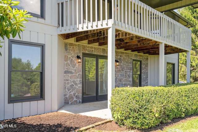 119 Orchard Meadows Ln, Roan Mountain, TN 37687 - entrance to property with stone siding, board and batten siding, and a balcony