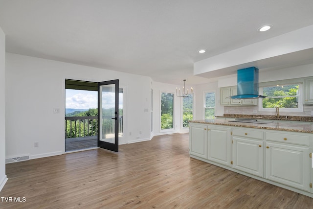 119 Orchard Meadows Ln, Roan Mountain, TN 37687 - kitchen with extractor fan, a chandelier, light wood-style floors, recessed lighting, and white cabinets