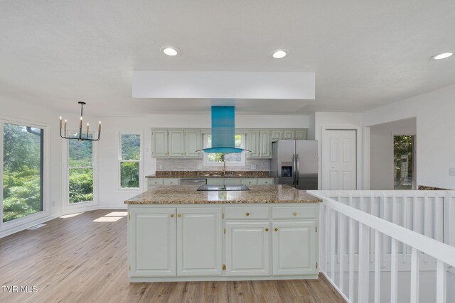 119 Orchard Meadows Ln, Roan Mountain, TN 37687 - kitchen with stainless steel appliances, wall chimney exhaust hood, light wood-style flooring, a chandelier, and recessed lighting