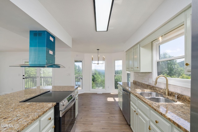 119 Orchard Meadows Ln, Roan Mountain, TN 37687 - kitchen featuring stainless steel appliances, extractor fan, light wood-type flooring, and light stone counters