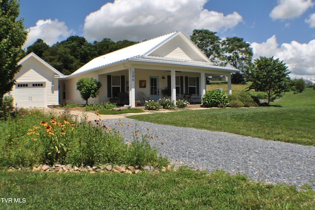 286 Sliger Rd, Jonesborough, TN 37659 - view of front facade with covered porch, a front lawn, a metal roof, a garage, and driveway