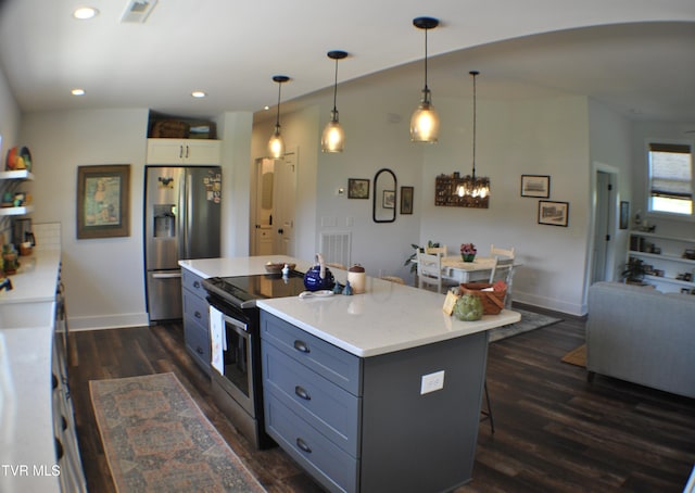 286 Sliger Rd, Jonesborough, TN 37659 - kitchen featuring appliances with stainless steel finishes, light countertops, gray cabinets, dark wood finished floors, and a kitchen bar