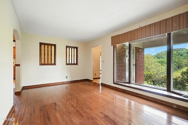 134 Richmond Hts, Jonesville, VA 24263 - empty room with hardwood / wood-style floors and arched walkways