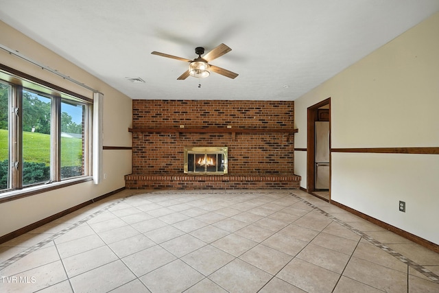 134 Richmond Hts, Jonesville, VA 24263 - unfurnished living room featuring a ceiling fan, light tile patterned floors, inlaid floor details, and a brick fireplace