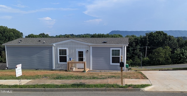 2311 Serenity Ct, Kingsport, TN 37665 - view of front of house with board and batten siding, a mountain view, and driveway