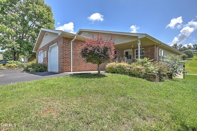 713 Teasel Dr Unit 0, Kingsport, TN 37660 - view of side of home featuring brick siding, a yard, an attached garage, and driveway
