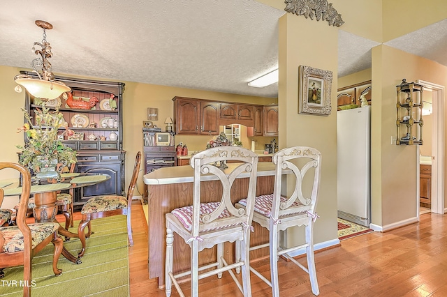 713 Teasel Dr Unit 0, Kingsport, TN 37660 - dining area with light wood-style flooring and a textured ceiling