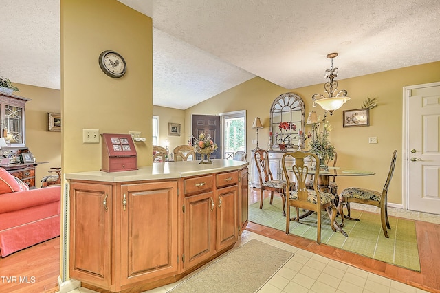713 Teasel Dr Unit 0, Kingsport, TN 37660 - kitchen with a textured ceiling, lofted ceiling, light countertops, light tile patterned floors, and hanging light fixtures