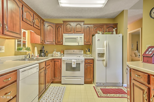 713 Teasel Dr Unit 0, Kingsport, TN 37660 - kitchen with white appliances, light countertops, a textured ceiling, light tile patterned flooring, and brown cabinetry