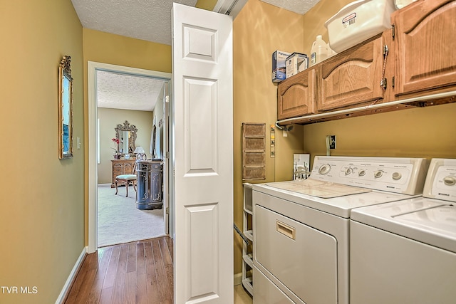 713 Teasel Dr Unit 0, Kingsport, TN 37660 - washroom featuring cabinet space, a textured ceiling, washing machine and dryer, and dark wood-style floors