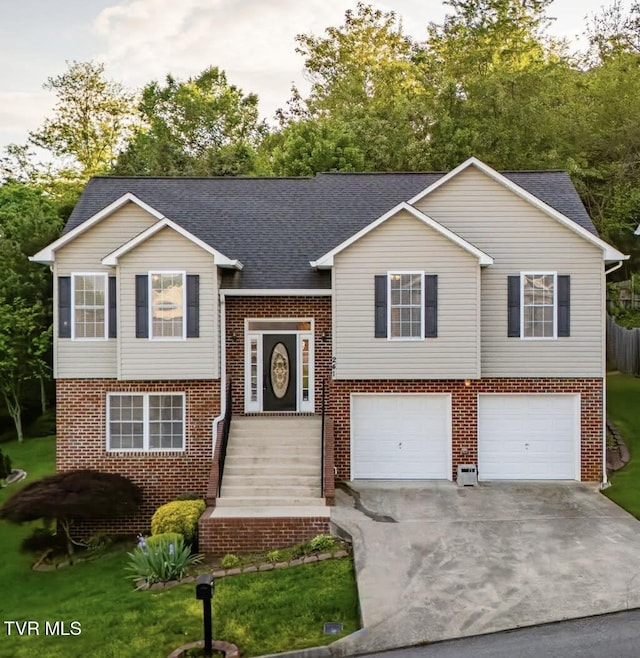 241 Stone Edge Cir, Kingsport, TN 37660 - bi-level home featuring an attached garage, brick siding, concrete driveway, and a shingled roof