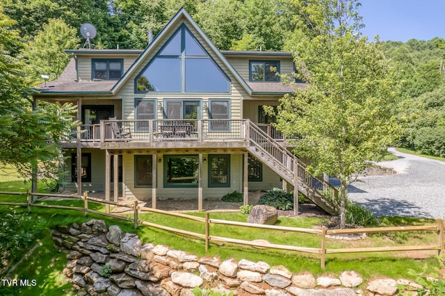 410 Eagle Ridge Rd, Roan Mountain, TN 37687 - back of property featuring a wooden deck, stairway, and a shingled roof