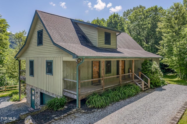 410 Eagle Ridge Rd, Roan Mountain, TN 37687 - view of front facade with covered porch, roof with shingles, a garage, and board and batten siding