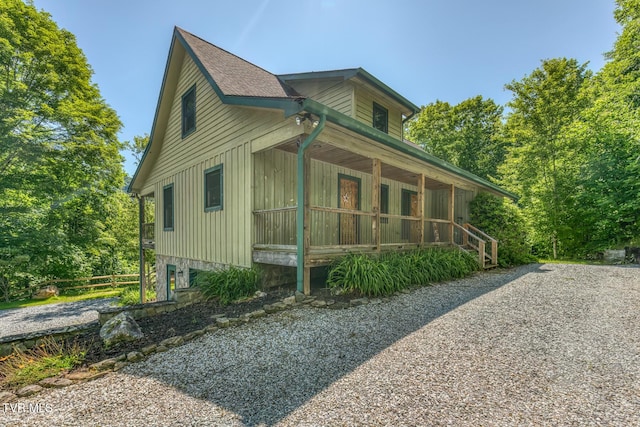 410 Eagle Ridge Rd, Roan Mountain, TN 37687 - view of home's exterior with board and batten siding, covered porch, and a shingled roof