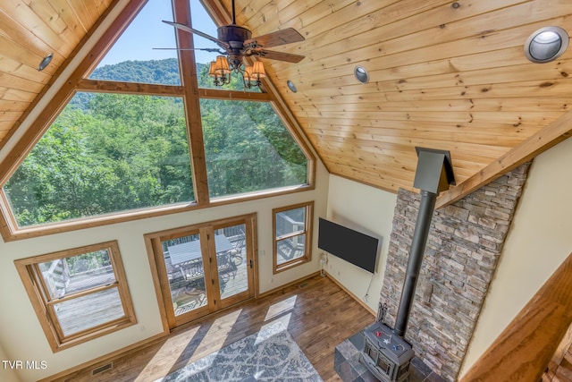 410 Eagle Ridge Rd, Roan Mountain, TN 37687 - unfurnished living room with wooden ceiling, plenty of natural light, a wood stove, high vaulted ceiling, and ceiling fan