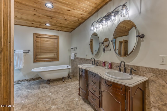 410 Eagle Ridge Rd, Roan Mountain, TN 37687 - full bathroom featuring wooden ceiling, tile walls, double vanity, a freestanding bath, and a wainscoted wall