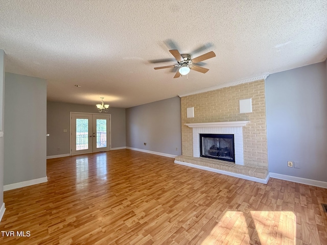 130 Kiser Cir, Jonesborough, TN 37659 - unfurnished living room with light wood finished floors, a textured ceiling, ceiling fan, a fireplace, and french doors