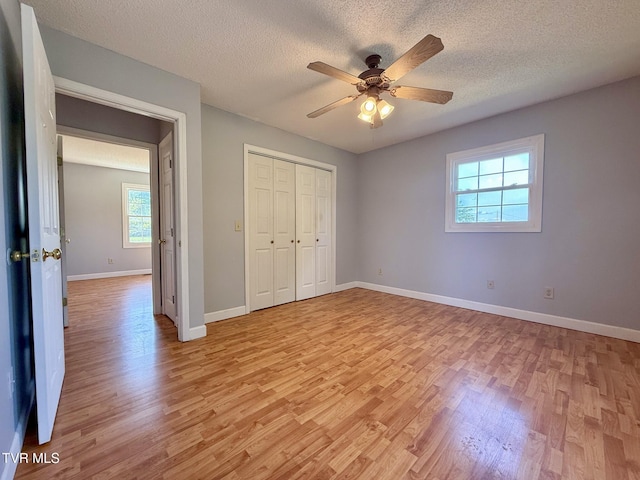 130 Kiser Cir, Jonesborough, TN 37659 - unfurnished bedroom with light wood-type flooring, a textured ceiling, a closet, and ceiling fan
