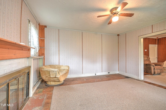 1230 Carolina Ave, Bristol, TN 37620 - unfurnished room with a brick fireplace, a ceiling fan, a textured ceiling, crown molding, and wallpapered walls