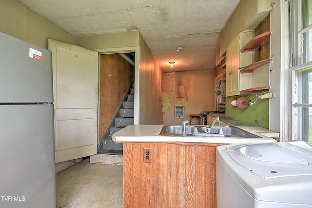 1230 Carolina Ave, Bristol, TN 37620 - kitchen with washer / clothes dryer, freestanding refrigerator, a peninsula, concrete flooring, and open shelves