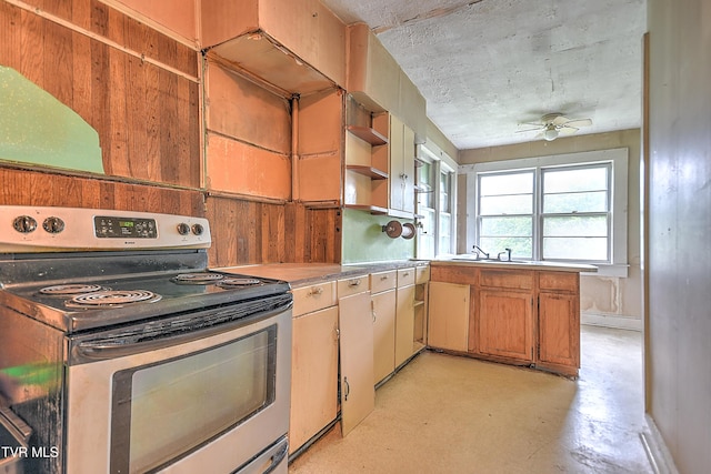 1230 Carolina Ave, Bristol, TN 37620 - kitchen with stainless steel electric range oven, open shelves, ceiling fan, light countertops, and concrete floors