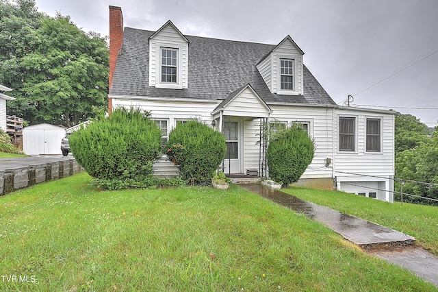 1230 Carolina Ave, Bristol, TN 37620 - cape cod house with a front lawn, a chimney, a shed, and roof with shingles
