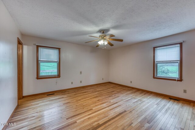 15060 Peaceful Valley Rd, Abingdon, VA 24210 - spare room featuring healthy amount of natural light, light wood-style floors, ceiling fan, and a textured ceiling