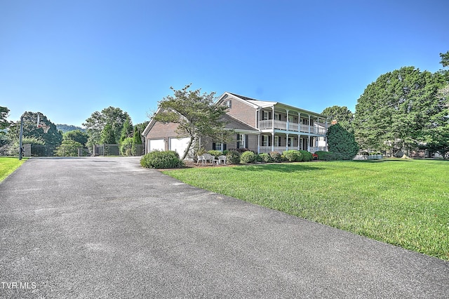 6054 Old Jonesboro Rd, Bristol, TN 37620 - view of front of house featuring asphalt driveway, a front lawn, an attached garage, and a balcony