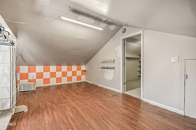 6054 Old Jonesboro Rd, Bristol, TN 37620 - additional living space featuring wood finished floors, vaulted ceiling, and an AC wall unit