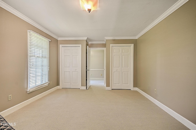 6054 Old Jonesboro Rd, Bristol, TN 37620 - unfurnished bedroom featuring ornamental molding, light colored carpet, and multiple closets
