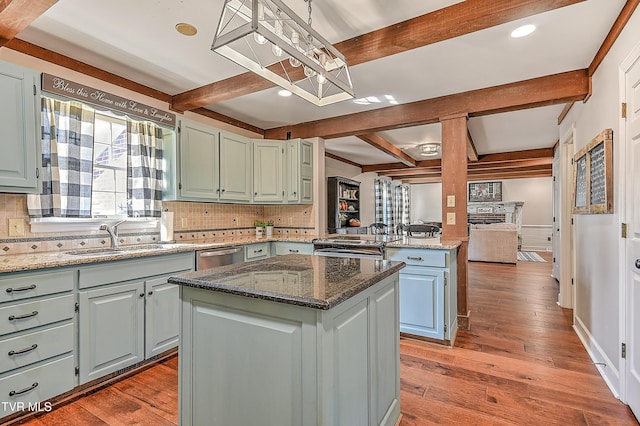 6054 Old Jonesboro Rd, Bristol, TN 37620 - kitchen with beam ceiling, tasteful backsplash, a kitchen island, a peninsula, and hardwood / wood-style floors