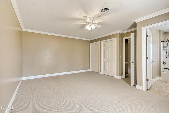 6054 Old Jonesboro Rd, Bristol, TN 37620 - unfurnished bedroom with light colored carpet, two closets, ornamental molding, connected bathroom, and ceiling fan