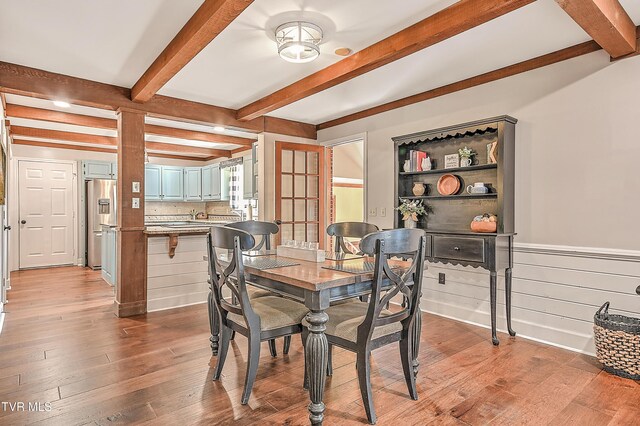 6054 Old Jonesboro Rd, Bristol, TN 37620 - dining space featuring wood finished floors, beam ceiling, and a wainscoted wall