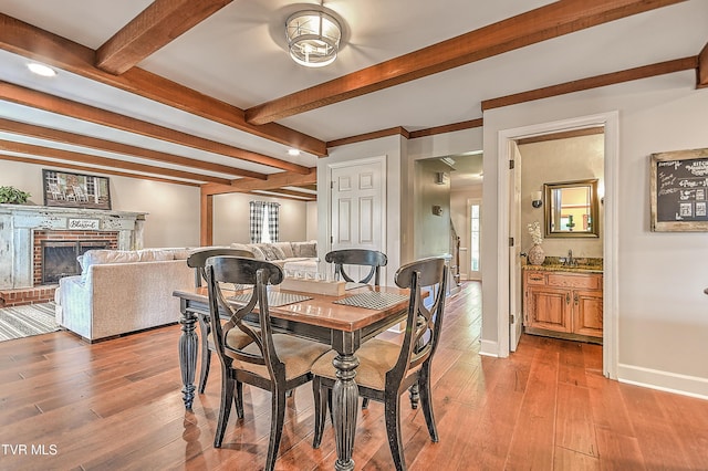6054 Old Jonesboro Rd, Bristol, TN 37620 - dining area featuring beamed ceiling, light wood finished floors, and a fireplace