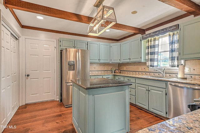 6054 Old Jonesboro Rd, Bristol, TN 37620 - kitchen featuring appliances with stainless steel finishes, beam ceiling, dark wood-type flooring, decorative backsplash, and dark stone counters