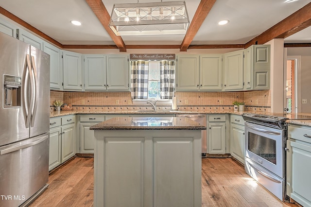 6054 Old Jonesboro Rd, Bristol, TN 37620 - kitchen featuring stainless steel appliances, beam ceiling, light stone countertops, light wood-style floors, and backsplash