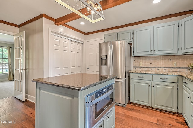 6054 Old Jonesboro Rd, Bristol, TN 37620 - kitchen featuring stainless steel appliances, dark stone counters, backsplash, a center island, and light wood-type flooring