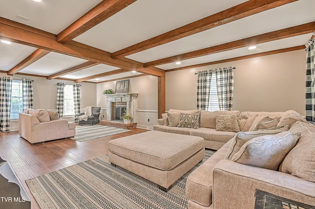 6054 Old Jonesboro Rd, Bristol, TN 37620 - living room featuring beamed ceiling, a brick fireplace, wood finished floors, a wainscoted wall, and recessed lighting
