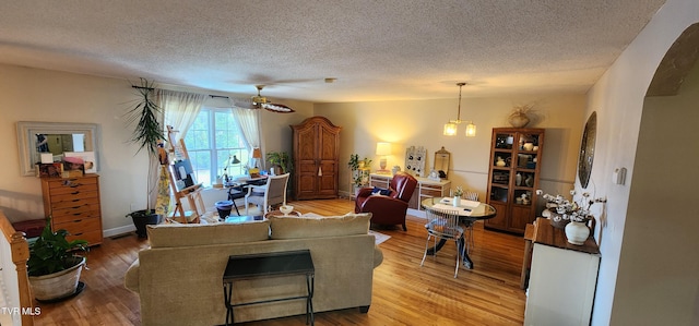 312 Old Franklin Pl Unit 5, Jonesborough, TN 37659 - living room with a textured ceiling, light wood finished floors, a ceiling fan, and arched walkways