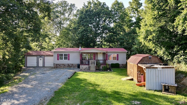 943 Newman Hollow Rd, Bean Station, TN 37708 - ranch-style home featuring covered porch, an outdoor structure, a front lawn, a metal roof, and gravel driveway