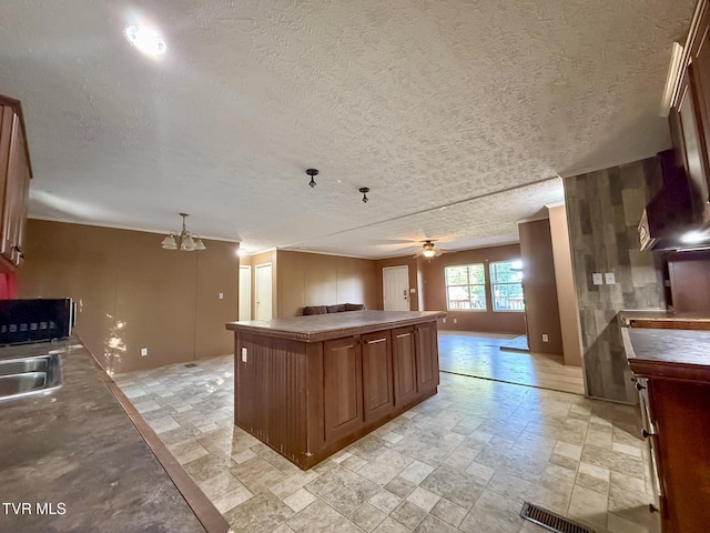 943 Newman Hollow Rd, Bean Station, TN 37708 - kitchen with open floor plan, stone tile floors, a textured ceiling, ceiling fan, and a center island