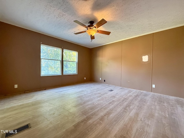 943 Newman Hollow Rd, Bean Station, TN 37708 - unfurnished room with a textured ceiling, a ceiling fan, and wood finished floors